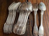 several forks and spoons are sitting on a wooden table