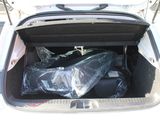 the trunk of a car with a bag of luggage in it