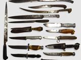 many different types of knives on a white surface