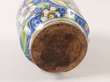 a vase that has a blue and green design on it