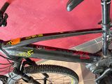 a close up of a bicycle with a red wall in the background