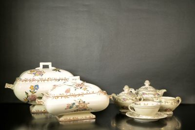 three different types of teapots and saucers on a table