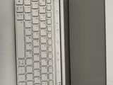 a tablet and a keyboard on a white table