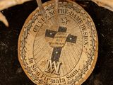 a cross on top of a coin on a table