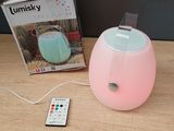 a remote control sitting on a table next to a lamp