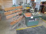a machine that is sitting in a room with many pieces of wood on it
