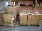 many boxes that are sitting on pallets in the room