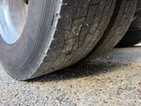 a close up of a flat tire on a truck