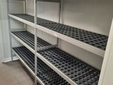 many shelves in the room that have black dots on them