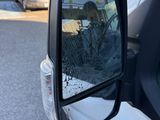 a side view mirror of a car with a dog in it