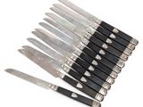 a bunch of knives that are sitting on a table