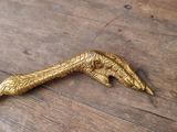 a gold bird that is sitting on a wooden table