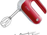 a red hand mixer with a whisk attachment next to it