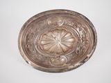 a silver plate with a flower design on it