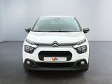the front view of a white citrole parked in a room