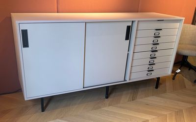 a white cabinet with drawers on it in a room