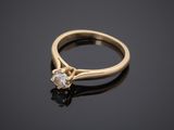 a yellow gold engagement ring with a single diamond
