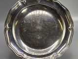 a silver plate with a flower design on the rim