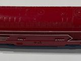 a red toy train on a white surface