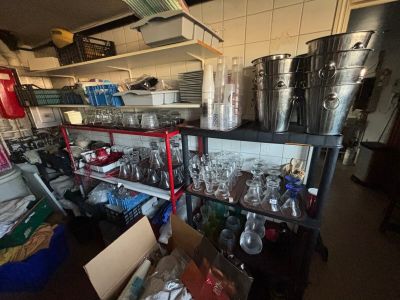 many pots and pans on the shelves in the kitchen