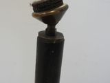 a toothbrush that is sitting on top of a wooden pole