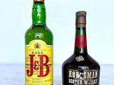 two bottles of liquor sitting next to each other on a table