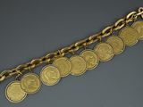 a close up of a gold bracelet with coins on it