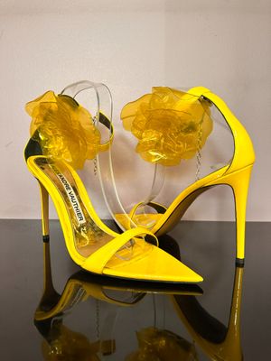 a close up of a pair of yellow shoes on a table