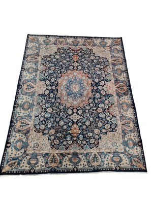a blue and beige rug with a medallion design on it
