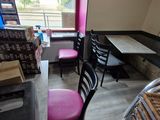 a table and chairs in a room with a window