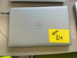 two laptops sitting on a desk with a yellow sticker on it
