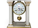 a white clock that is sitting on a table