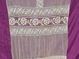 an image of a purple dress with white lace on it