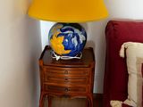 a lamp that is sitting on a table next to a red couch
