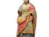 an old statue of a woman holding a baby in her arms