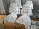 several chairs are lined up in a row on a wooden floor