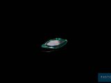 a small boat floating in the water at night