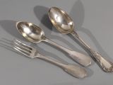 three spoons and a fork on a table