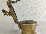 antique brass teapot with handle on a white table