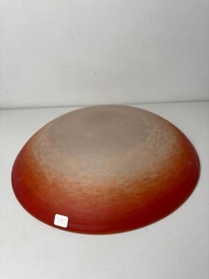 a red and white plate sitting on a white surface