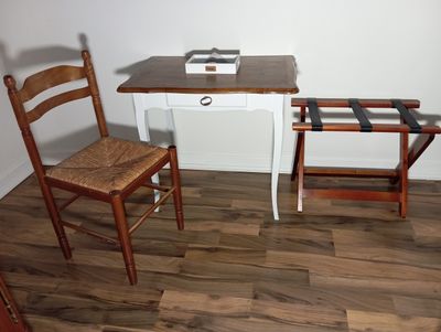 a small desk with a chair and a computer on it