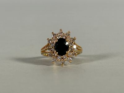 a close up of a black and white diamond ring on a table