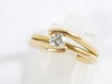 a close up of a gold ring with a diamond on it