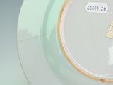 a plate with a tag on it sitting on a table