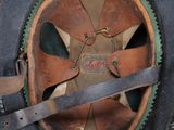 a close up of a hat with a knife in it