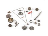 an image of a collection of silver jewelry on a white surface