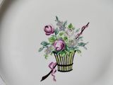 a plate with a basket of flowers painted on it