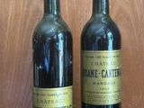 two bottles of wine sitting next to each other on a table