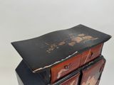 a black and red chest of drawers on a white background