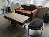 a living room with a couch, coffee table, and ottoman